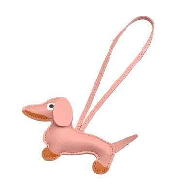 Pink dachshund-shaped keychain on a white background